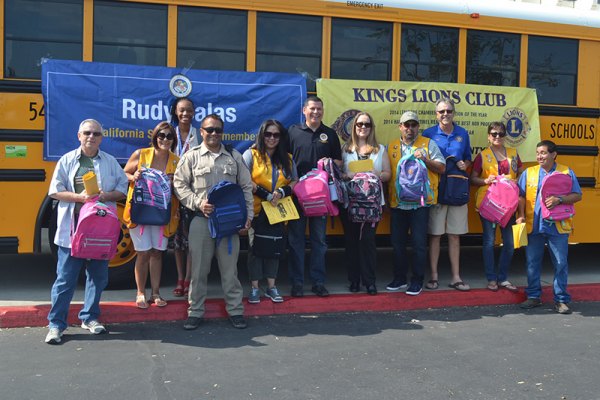 Assembly Member Rudy Salas joins Kings Lions Club members and others at the annual "Stuff the Bus" event Saturday at the Lemoore Kmart.